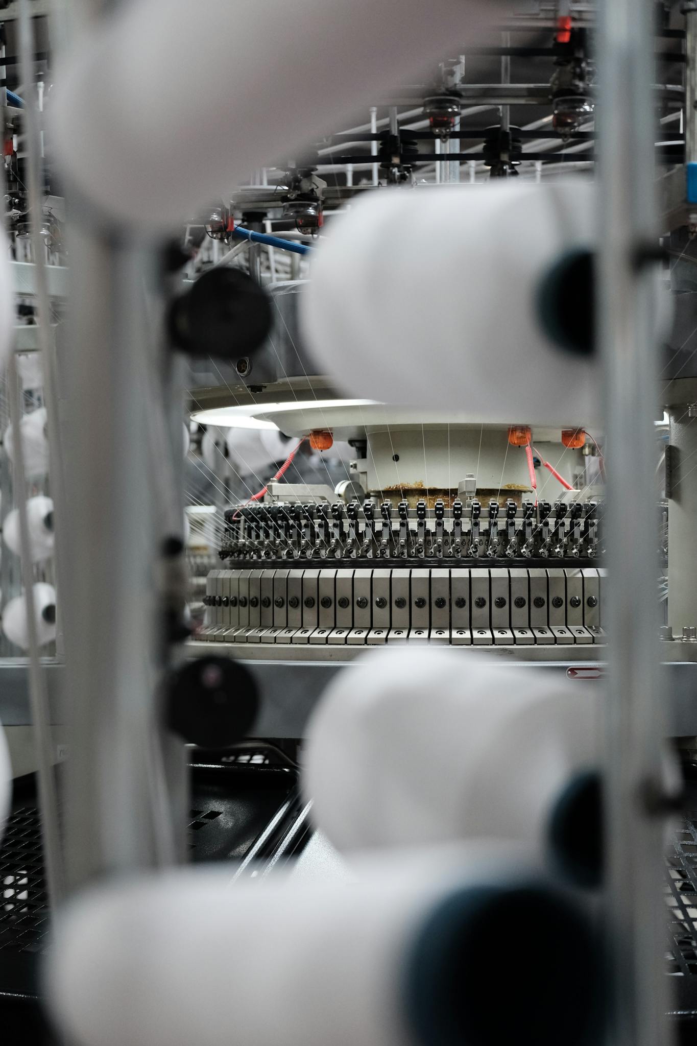 Close-up view of a textile spinning machine in operation, showcasing its intricate design.