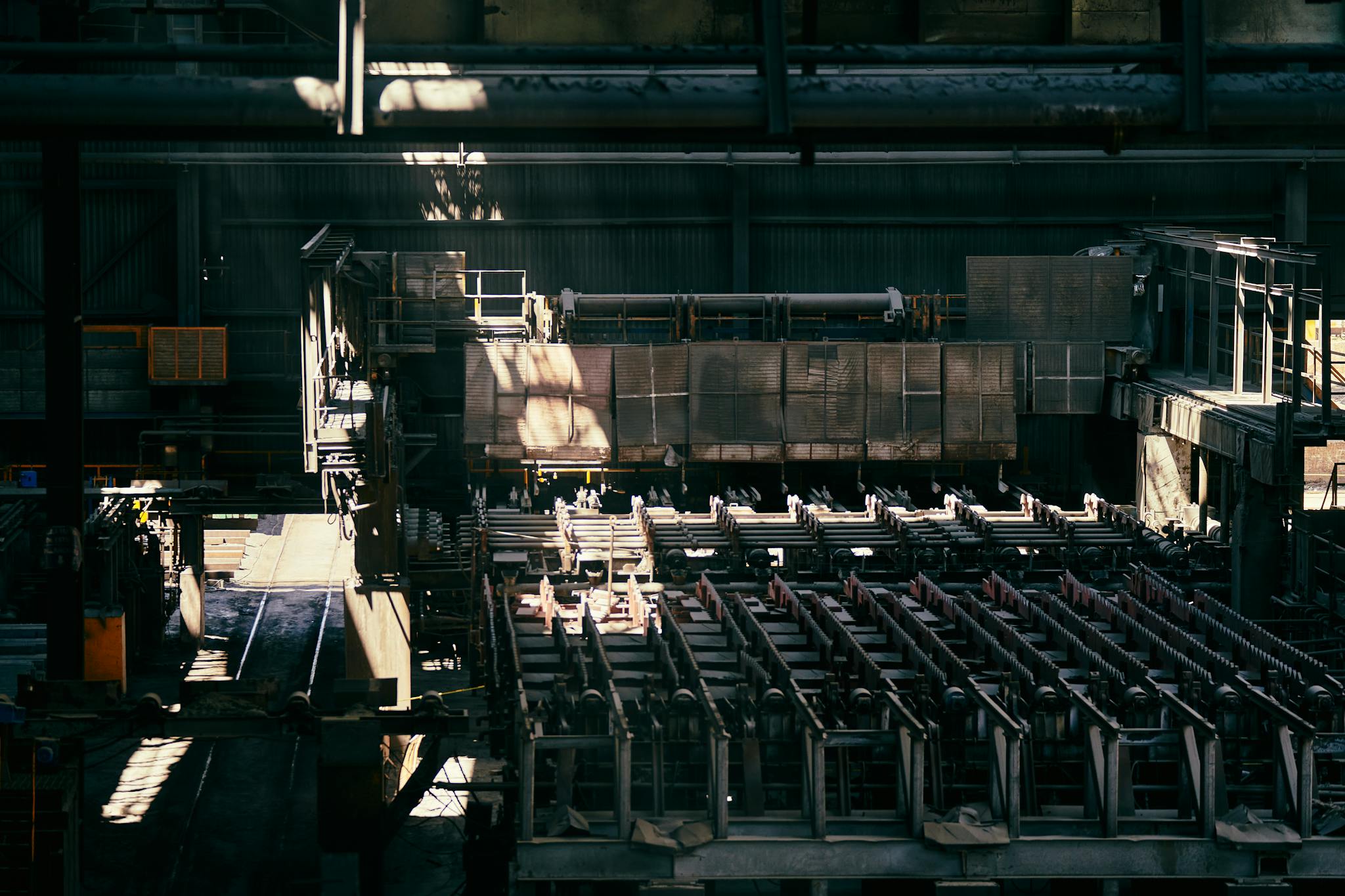 Interior view of a large industrial factory featuring machinery and equipment.