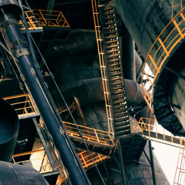 Intricate view of metal stairs and structures in a large industrial facility.